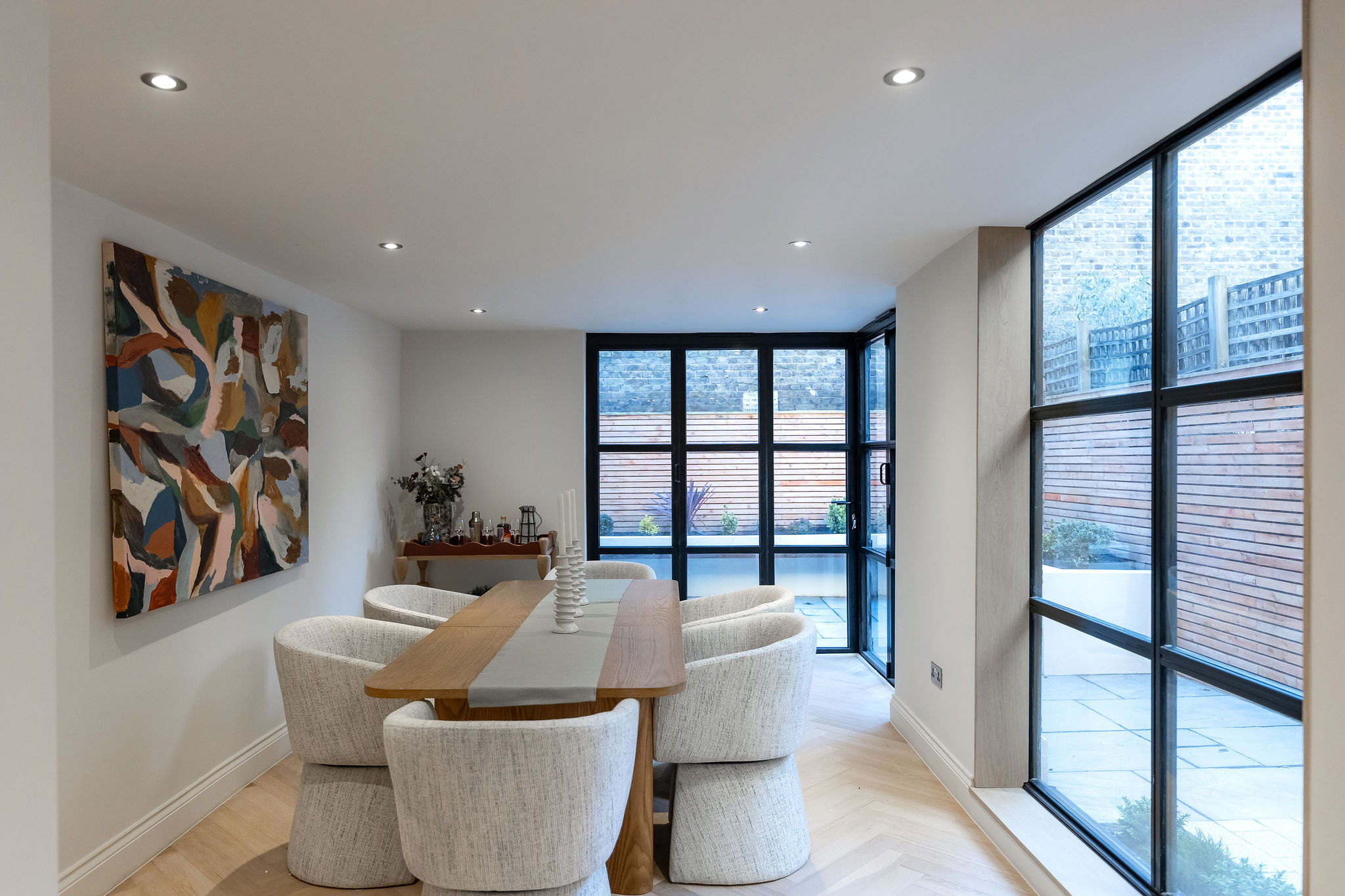 Turkish styled room design with an urban brick feature wall and fitted turkish rug including plant decorations. Iloft conversions ltd loft revamp and remodeling service